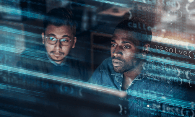 Two male employees focusing on computer screen